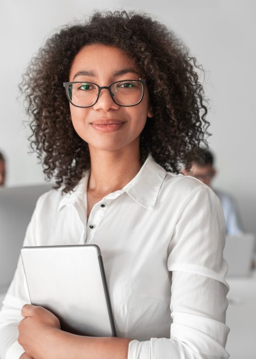 smiling-ethnic-female-recruiter-with-tablet-looking-at-camera-in-office.jpg